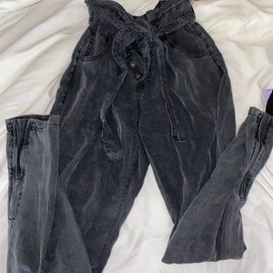 jean-like joggers with buttons and a belt, also zippers on the bottom